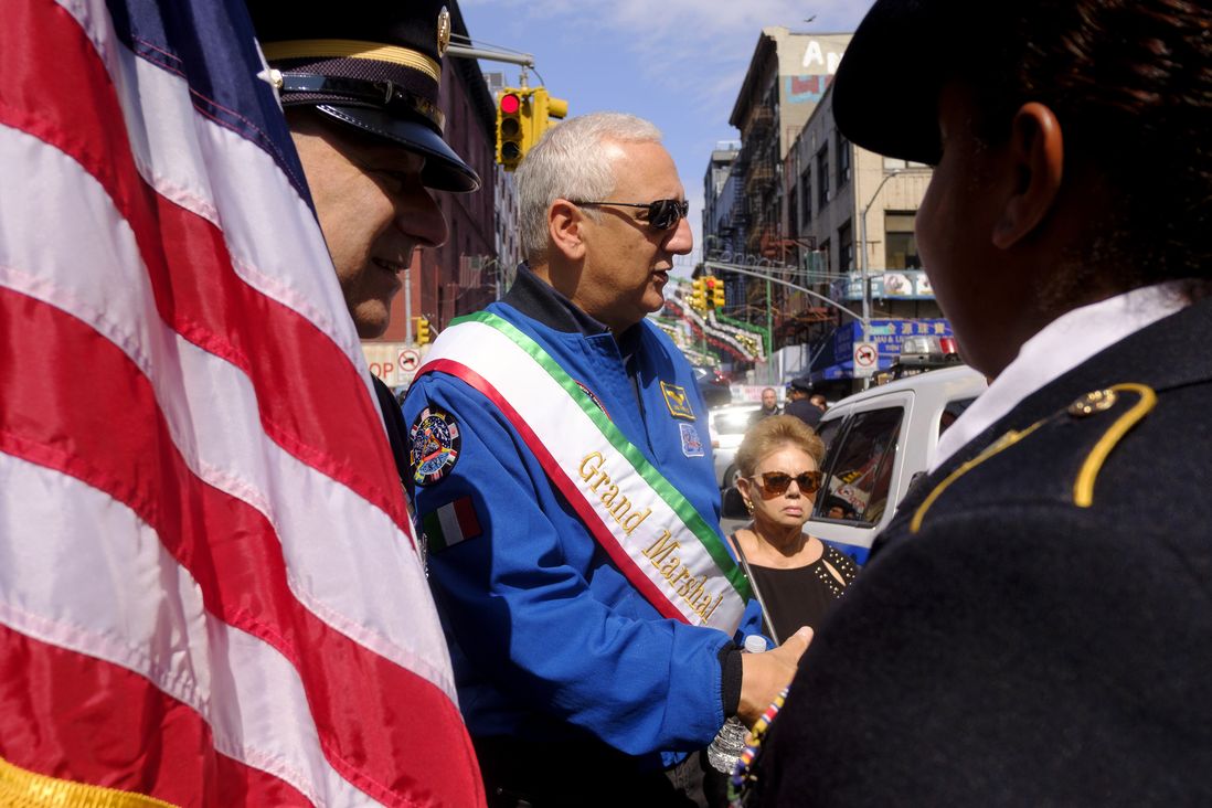 NASA Astronaut Mike Massimino, the Procession’s Grand Marshall, talks to members of an Army Color Guard unit prior to the start of the procession.